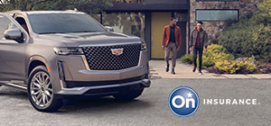 A woman is standing at the passenger door of a Cadillac Escalade while two men walk out of a very modern stone home in the background. OnStar Insurance logo is in the bottom right hand corner of the image